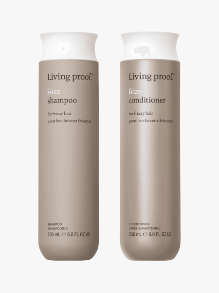 Living Proof No Frizz Shampoo and Conditioner in branded components on a light gray background